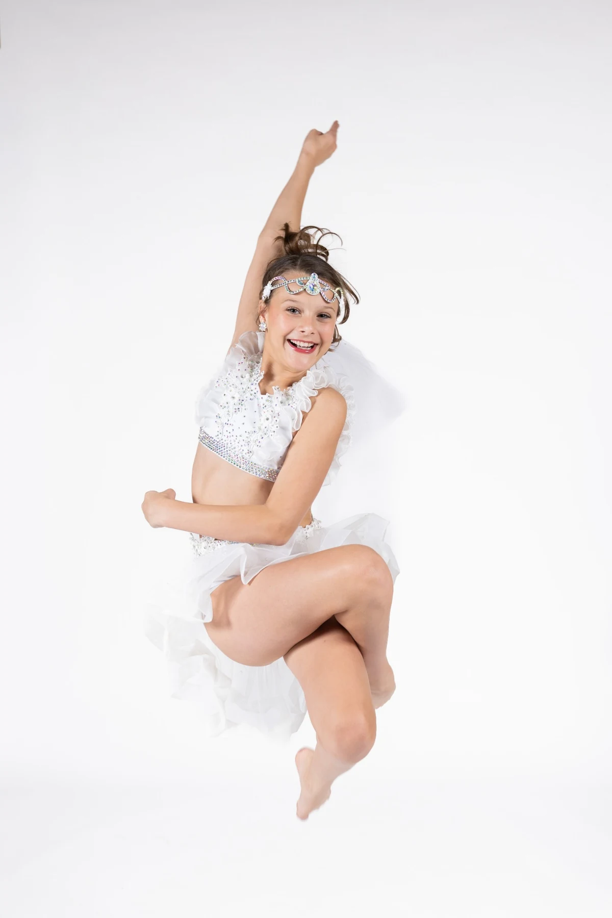 Young dancer smiling in a white performance costume